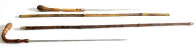 Lot 343 - A Bamboo Swordstick, with 42cm square section steel blade, the haft with foliate embossed white...