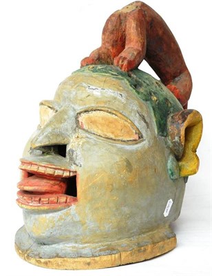 Lot 387 - A Yoruba Gilede Funerary Helmet Mask, Nigeria, with large blank eyes, flaring nostrils, open...