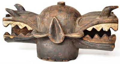 Lot 388 - A Senufo Wood Janus Mask, Ivory Coast, carved as a stylised warthog, 56cm (af)