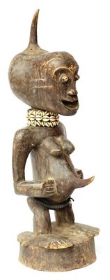 Lot 393 - A Songye Reliquary Guardian/Community Figure, DCR, of a woman with an animal horn protruding...