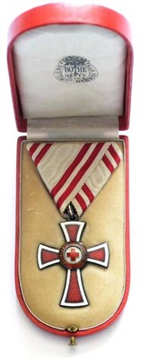 Lot 43 - An Austrian Honour Decoration of the Red Cross, in silvered bronze and red enamel, with ribbon...