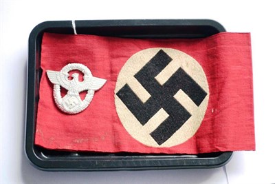 Lot 215 - A German Third Reich NSDAP Armband, in red cotton embroidered with a black swastika on a white...