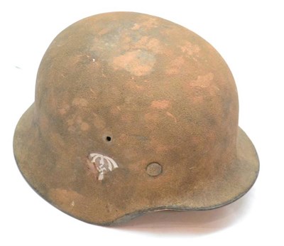 Lot 217 - A German Third Reich M35 Helmet, the shell covered in tan paint mixed with sand camouflage with...