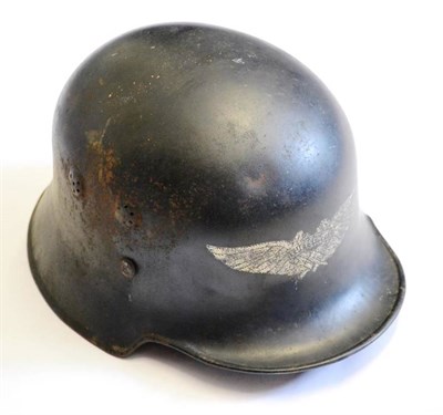 Lot 220 - A German Third Reich Luftschutz Helmet, painted black with silvered decal, leather liner with...