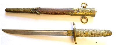 Lot 242 - A Second World War Japanese Naval Dirk, the 20cm single edge steel blade with a narrow fuller...