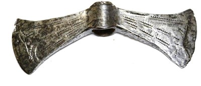 Lot 292 - A Double Bladed Axe Head, with a central socket flanked by down-curved fan shape blades incised...