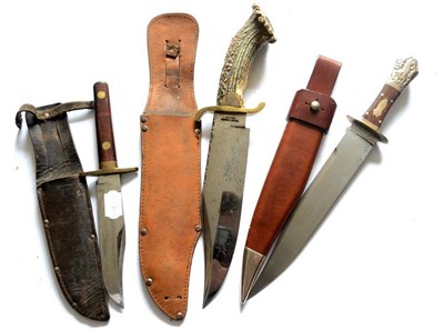 Lot 324 - Three Modern Bowie Knives, one with antler handle, one with teak handle with finger notches,...