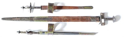 Lot 367 - A Tuareg Telek, with 40cm double edge steel blade, with cruciform wood and brass hilt with cap...