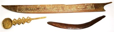 Lot 408 - An Australian Aborigine Boomerang, with shallow groove decoration, one side rounded, 49cm; a...