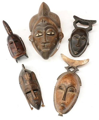 Lot 439 - A Punu, Gabon Wood Mask, with combed triple lobed coiffure, pierced and painted elliptical...