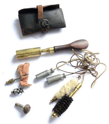 Lot 447 - A 12 Bore Gun Cleaning Kit, comprising a leather pouch containing a pull-through and various...