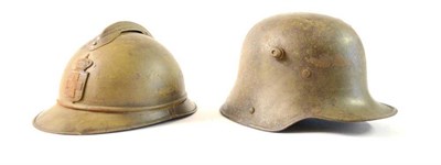 Lot 139 - A First World War German M16 helmet, lacks liner; an Adrian Fire Helmet, with raised comb, the...