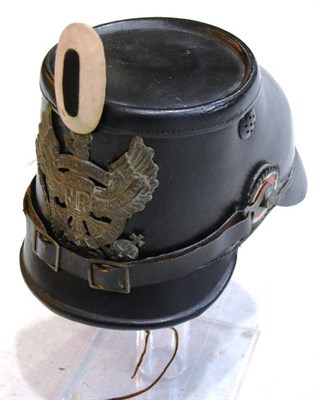 Lot 148 - A Prussian Black Leather Shako, the brass helmet plate with WATERLOO bandeau, with white cloth...