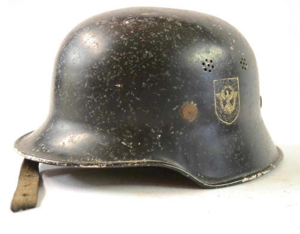 Lot 177 - A German Third Reich M34 Fire Police Helmet, with black painted finish, double decals, the...