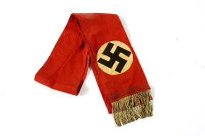 Lot 180 - A German Third Reich NSDAP Funeral Sash, the red cotton ground applied with a black swastika on...