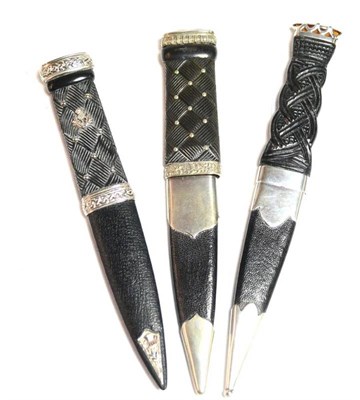 Lot 242 - A Scottish Skein Dhu, with single edge scallop edge steel blade, ebony grip carved on one side with