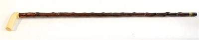 Lot 246 - A 19th Century Holly Swordstick, the 70cm single edge fullered steel blade etched on one side...