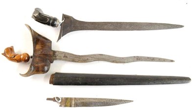 Lot 252 - A Malayan Kris, with 36cm five lok double edge fullered pamor steel blade, flame figured wood...