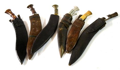 Lot 278 - An Indian Kukri, with wood grip and foliate carved two piece wood scabbard; five Various...