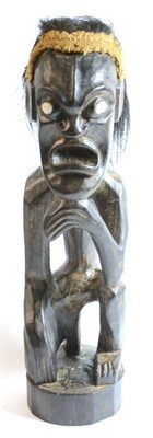 Lot 295 - A South Seas Islands Wood Ancestor Figure, possibly Haiwian, half kneeling with his chin resting on