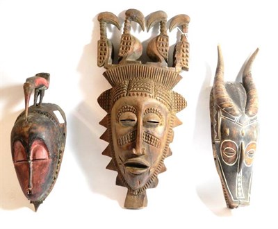 Lot 298 - A Baule, Ivory Coast Wood Mask, the oval face with pierced swollen eyelids, long aquiline nose,...