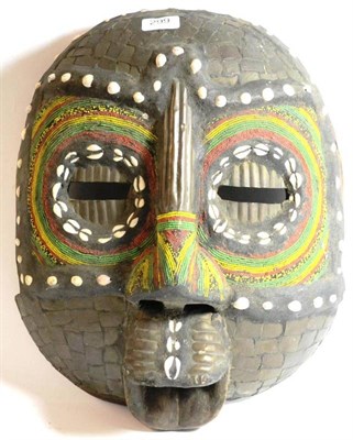 Lot 299 - A West African Large Mask, of rounded square section, with pierced eyes within circular...