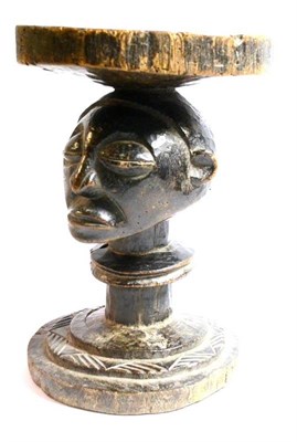 Lot 306 - A Luba, DRC Wood Stool, the slightly dished circular seat supported on the bust head of a man, on a