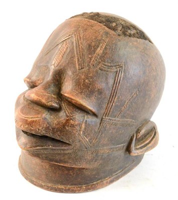 Lot 307 - A Makonde Wood Helmet Mask, Tanzania, the skull with a shaped panel inset with close shaven...