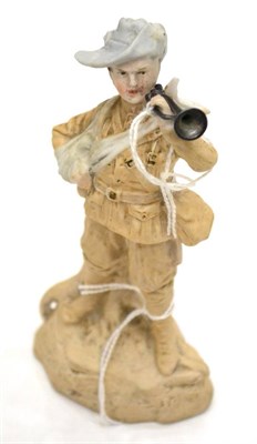 Lot 49 - A German Bisque Porcelain Figure of Bugler Dunne, standing, his arm in a sling, a metal bugle...