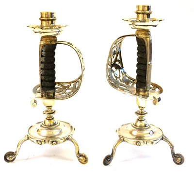 Lot 83 - A Pair of Silver Plated Candlesticks, each made from the hilt of a cavalry sword surmounted by...