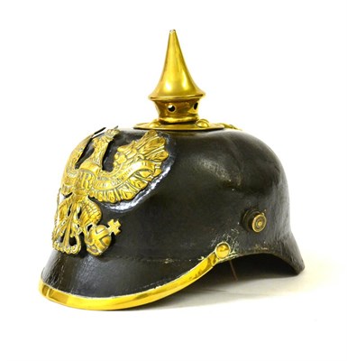 Lot 101 - A Prussian Enlisted Leather Pickelhaube, post-1895 pattern, the fixed brass spike with pierced...