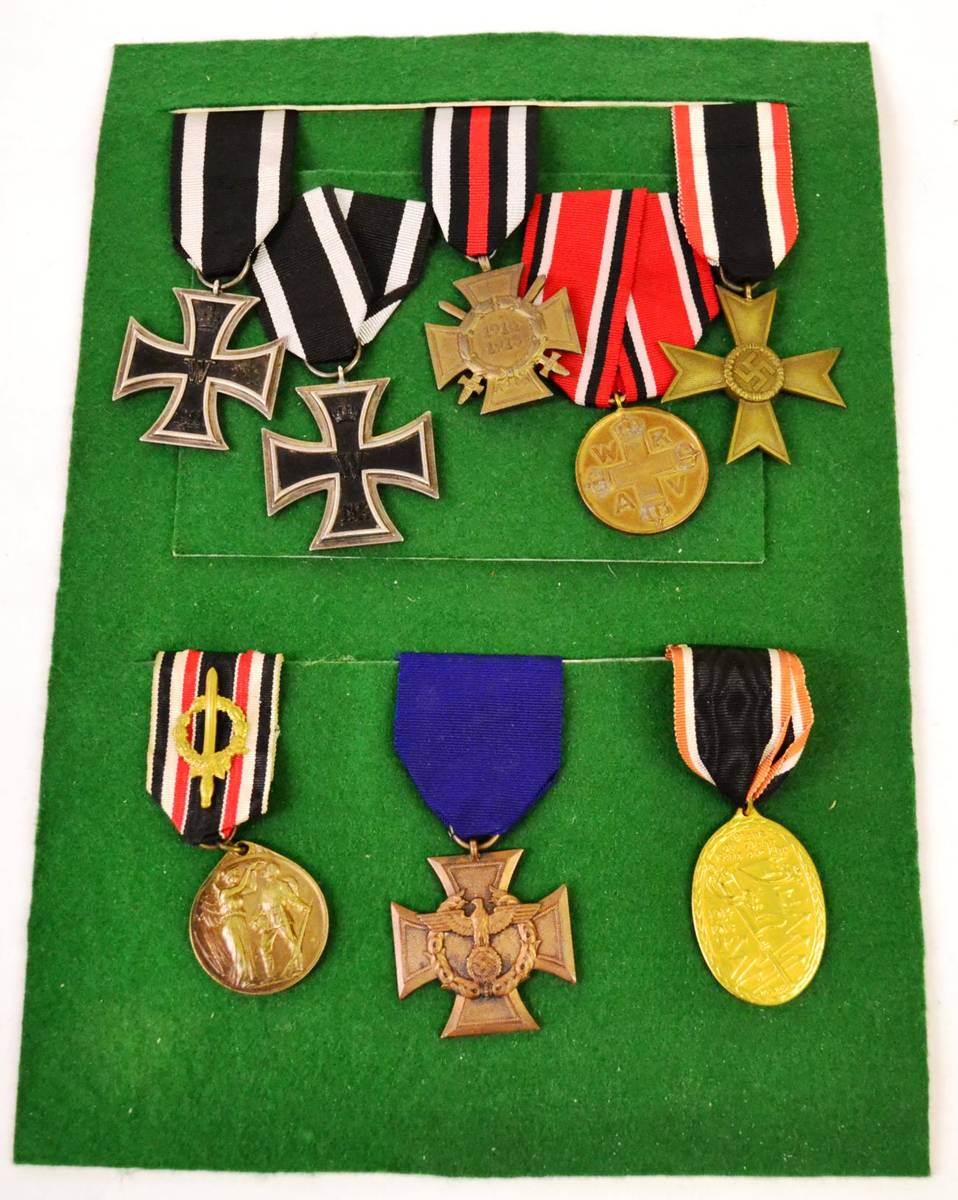 Lot 147 - A German First World War Iron Cross and Red Cross Medal, mounted on a green display card; a Display
