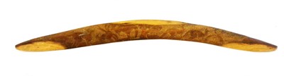 Lot 314 - An Australian Aborigine Boomerang, one side lightly carved with kangaroos on a diapered field,...