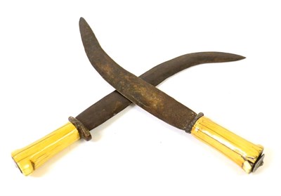 Lot 319 - Two Dinka Knives, Sudan, each with 28cm double edge curved steel blade, short wood crossguard...