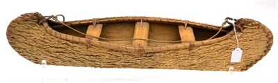 Lot 330 - A Canadian Indian Elm Bark Model of a Canoe, constructed from one piece, steamed and bent, the...