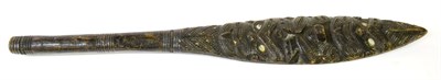 Lot 333 - A Maori Paddle, circa 1920, of ebonised softwood, one side carved with two stylised Tekke type...