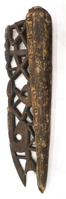 Lot 336 - An Asmat Wood Canoe Prow, carved from a single trunk, half of solid rounded form, half pierced...