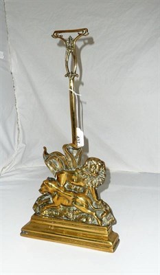 Lot 437 - A Cast Brass Lion and Lioness Doorstop, 19th century, with foliate loop handle, and lead...