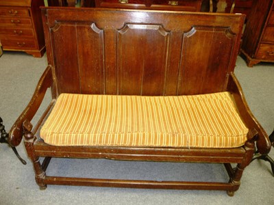 Lot 478 - An 18th Century Joined Oak Settle, the fielded panel back above downswept arms and squab...