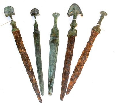 Lot 240 - A Collection of Five Luristan Bronze Daggers, circa 2nd - 1st millennium BC, three with similar...