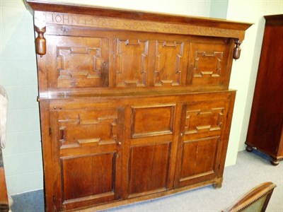 Lot 479 - A Joined Oak Press Cupboard, the bold canopy above a carved frieze titled JOHN MYRES AND JOYCE...