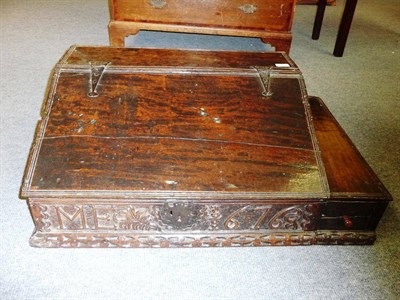 Lot 482 - A Carved Oak Boarded Desk Box, the hinged slope opening to reveal pigeon holes, the carved...