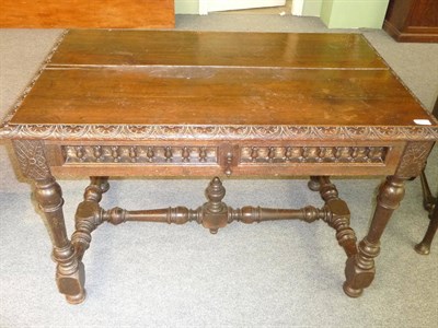 Lot 483 - A Joined Oak Writing Table, the rectangular top with carved edge above a single frieze...