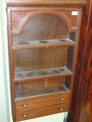 Lot 485 - An Oak Wall Cabinet, the bold cornice above a panelled and arched frieze, two fixed shelves...