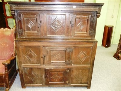 Lot 493 - A Joined Oak Press Cupboard, the bold cornice and canopy top above three fielded panel doors...