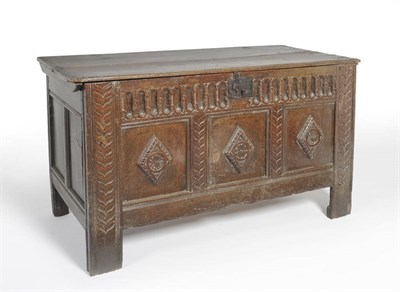 Lot 500 - A 17th Century Joined Oak Chest, the boarded lid over a fluted frieze with three fielded panels...