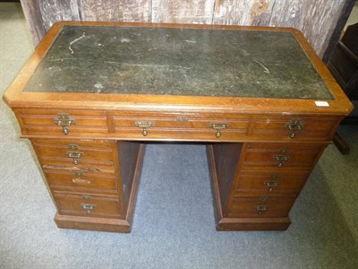 Lot 504 - An Edwardian Oak Double Pedestal Desk, the rectangular top inset with a green leather writing...