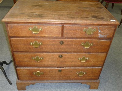 Lot 506 - A George III Oak Chest of Drawers, the rectangular moulded top above two short and three long...