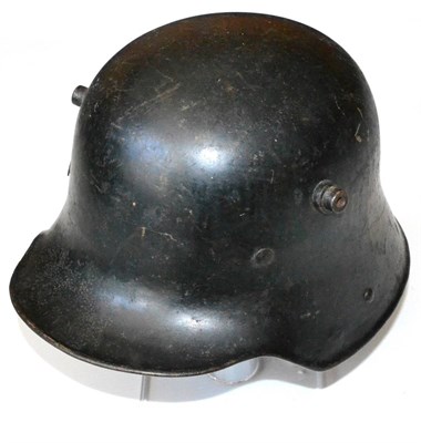 Lot 154 - A First World War German M1916 Army Helmet, painted black with scratched out later decals, the...