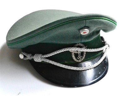 Lot 184 - A German Third Reich Schutzpolizei Officer's Visor Cap, in green twill with green velvet centreband